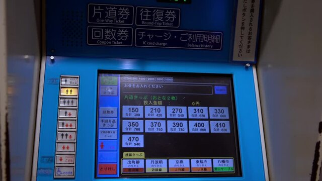 Japanese woman buying ticket at metro station in Kyoto. Tourist traveling on train in Japan. Subway underground fast transportation and asian commuters-Dan