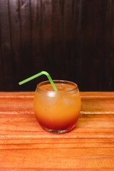 Daikiri cocktail in a glass tumbler on a wooden table.