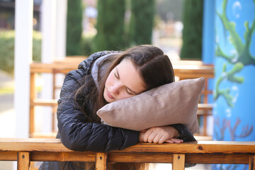 a girl with a pillow is resting in nature