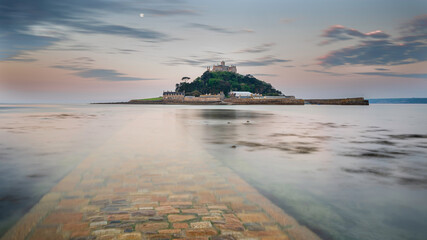 St. Michael's Mount, Cornwall, at sunrise. The causeway can be seen under the incoming tide, which...