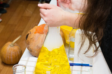 Experiments with chemistry for children during the halloween celebration
