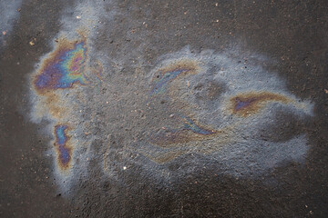 Oil slick on the asphalt road background
