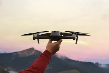 Fototapeta na wymiar Man with modern drone in mountains, closeup