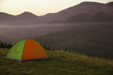 Camping tent on mountain slope in morning