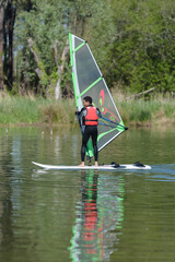a teenager bis doing windsurf