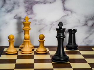 Classic Chess set with simple checkmate, wooden board and marble background