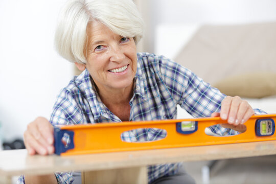 Senior Contractor Construction Worker Woman With Level