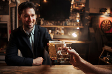 Caucasian customer sitting at bar having a drink with bartender 