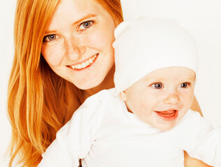 young beauty mother with baby, red head happy family isolated close up