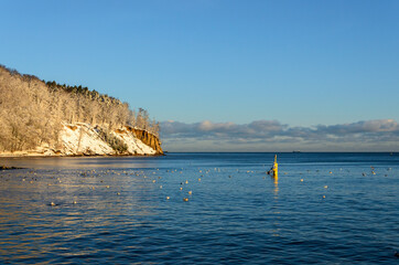Snow covered cliff in Gdynia Orlowo. Winter landscape, Baltic Sea, Poland.