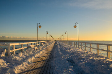 Snow covered pier in Gdynia Orlowo. Winter landscape, Baltic Sea, Poland.