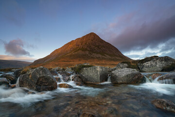 cascade waterfalls and fairy pools with the Devils point mountain located in the Cairngorms, highlands Scotland.