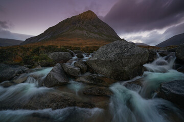 cascade waterfalls and fairy pools with the Devils point mountain located in the Cairngorms, highlands Scotland.