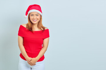 Beautiful asian woman wearing christmas dress standing and smiling looking at camera. Christmas concept