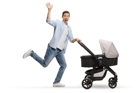 Full Length Profile Shot Of A Happy Excited Father Running With A Stroller And Waving At Camera