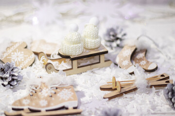 Fototapeta na wymiar wooden winter toys, Christmas concept, sledges, skis, skates, snow, cones, lights.