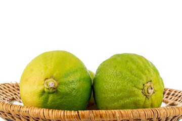 Two fragrant bergamots on a ceramic dish, close-up, isolated on white.