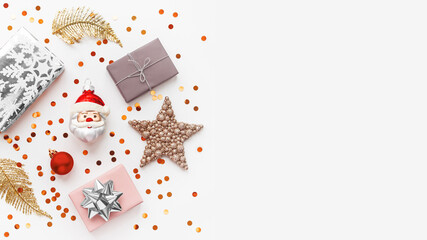 Christmas and New Year background with decorations. Santa Claus, golden feathers, silver presents and stars confetti. Copy space.