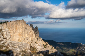 High rocks Ai-Petri of Crimean mountains. Black sea coast and blue sky with clouds in autumn. Russia