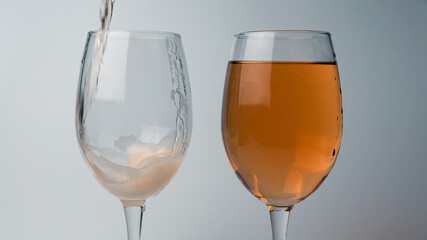 two glasses of champagne on white