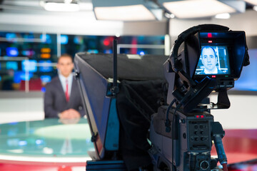 Video camera viewfinder view, recording show and news in TV studio - focus on camera Recording news
