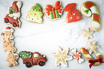Flat lay of Christmas gingerbread cookies with festive icing and Christmas decoration on the white background. Merry Christmas and Happy New Year.