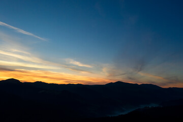 Silhouette of mountain landscape at sunset . Drone photography