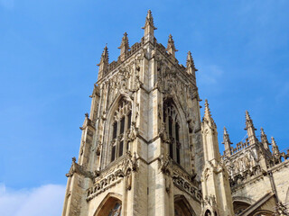 Fototapeta na wymiar Central or West tower of York Minster cathedral, England, UK, on a sunny summer day with blue sky. Selective focus.