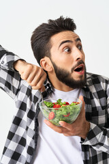 man in plaid shirt eating salad healthy food