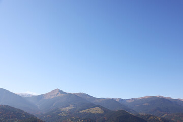 Fototapeta na wymiar Beautiful mountain landscape with forest on sunny autumn day