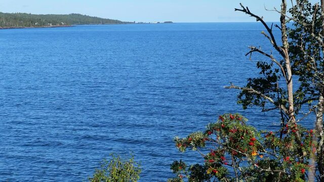 Beautiful blue water of Lake Superior or Gitchi Gami and shoreline, with Grand Marais, Minnesota in the distance.