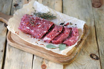 Fresh raw veal in paper. Farmed organic meat.
