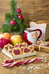 Apple cookies, apples and a red cup of black coffee near a wooden background. Dessert for breakfast. New Year's composition.
