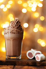 A chocolate cocktaile in glass with marshmallows on bokeh background