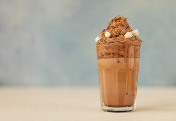 A chocolate cocktaile in glass with marshmallows on bokeh background