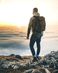 mountaineer standing on the mountain top at sunset in austria