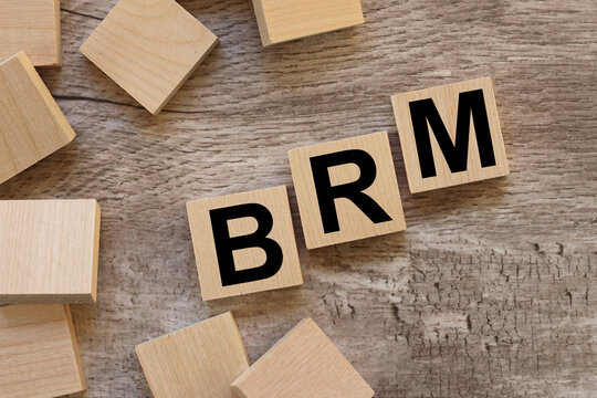 BRM. text on wooden blocks on a wooden background