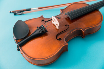 Fototapeta na wymiar Violin isolated on blue background