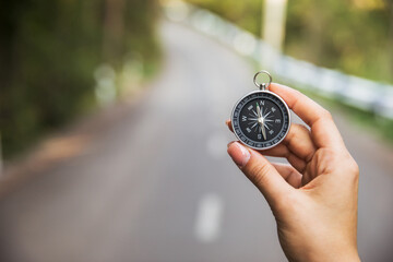 woman holding compass in road background