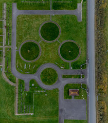 Pattern of circles in a green field and roundabout at Willow cemetery by Canvey wick in Essex, UK. Drone aerial drone top down view photo