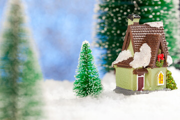 Fototapeta na wymiar Toy house in the snow, New Year's greeting card. Copy space, concept