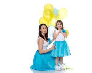 Mom and daughter with colorful balloons.