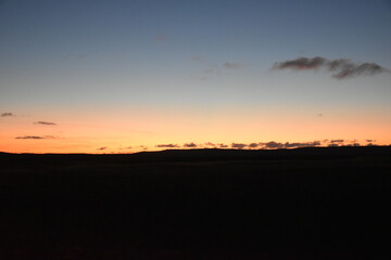 early morning dawn in the steppe over the hills