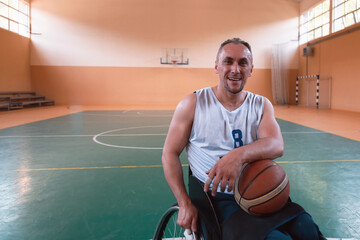 Fototapeta premium a portrait of a smiling wheelchair basketball player sitting in a wheelchair waiting for the game to begin