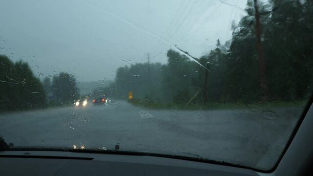 Pulled over to side of road in heavy rain storm. Cars passing with hazard lights. Good audio. Rural Ontario, Canada.