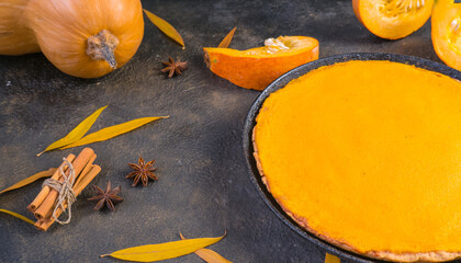 Traditional autumn dishes. Halloween, Thanksgiving. Spicy American Pumpkin Pie, on black with gold stone table.