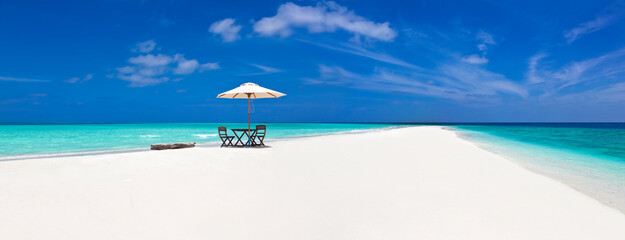 Beautiful Maldive panorama with parasol and boat.