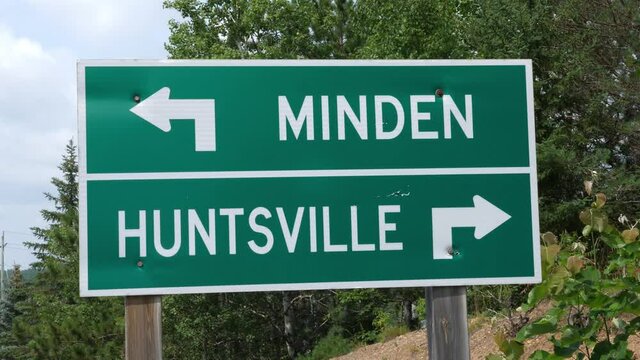 Tilt down to Minden and Huntsville road sign. Minden, Ontario, Canada.