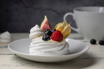 Sweet dessert, Pavlov's cake with butter cream and raspberry, blueberry, fig.
