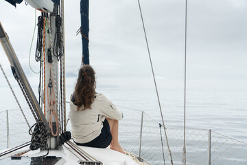 Woman sitting on a sailboat